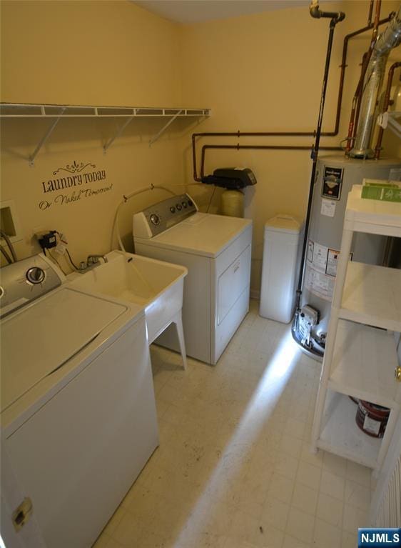 washroom featuring separate washer and dryer, sink, and gas water heater