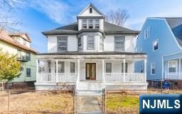 american foursquare style home with a porch