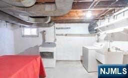 basement with sink and washing machine and clothes dryer