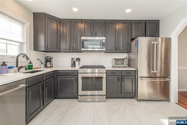 kitchen featuring sink, backsplash, and stainless steel appliances