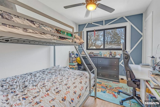 bedroom with hardwood / wood-style flooring and ceiling fan