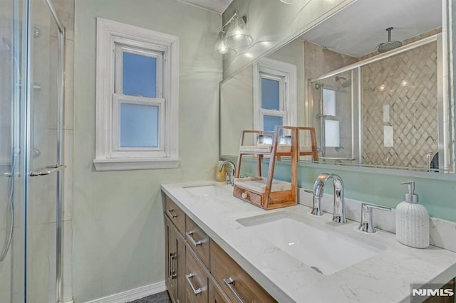 bathroom with vanity and a shower with door