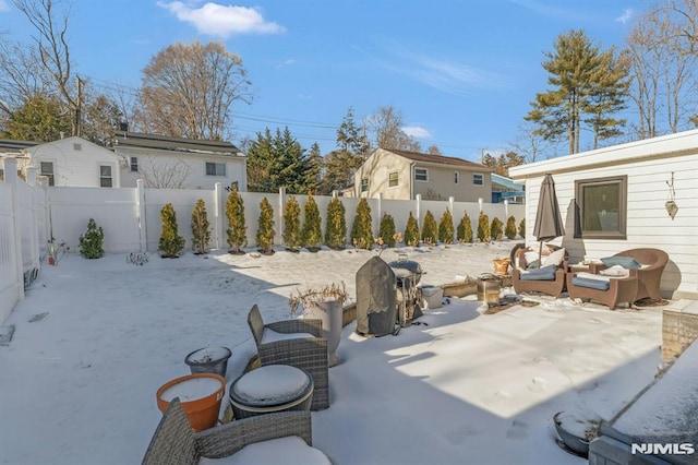 snow covered patio featuring an outdoor living space