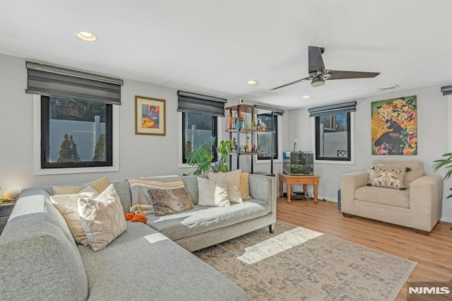 living room featuring hardwood / wood-style floors and ceiling fan