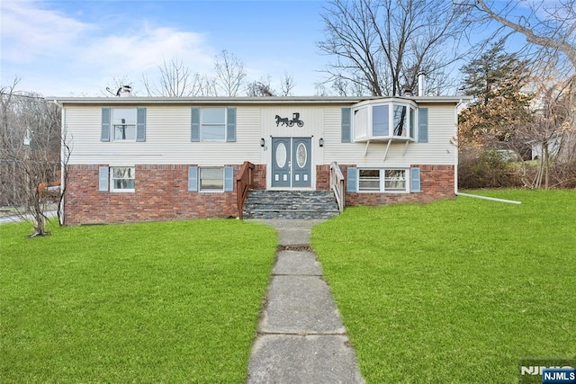 raised ranch featuring a front lawn