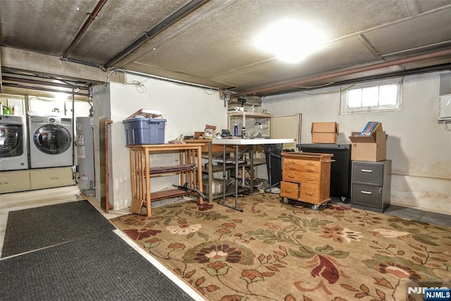 basement featuring a workshop area, gas water heater, and washing machine and dryer