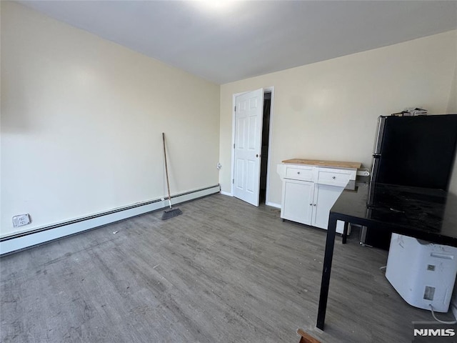 interior space with dark wood-type flooring and a baseboard radiator