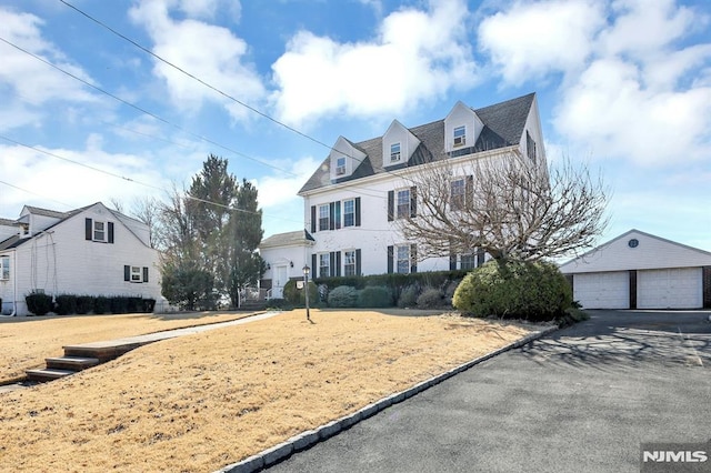 view of front facade with a garage and an outdoor structure