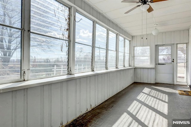 unfurnished sunroom with a ceiling fan