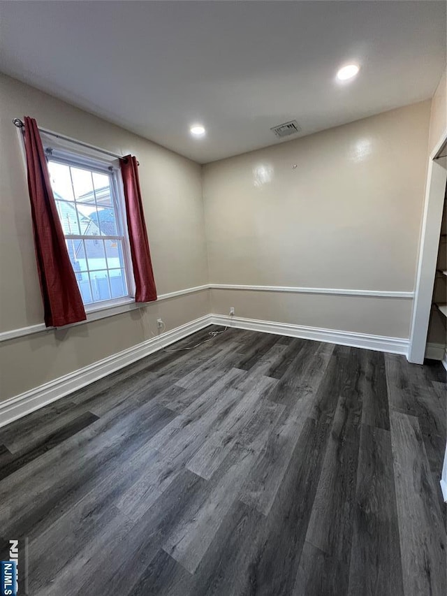 empty room featuring dark hardwood / wood-style flooring