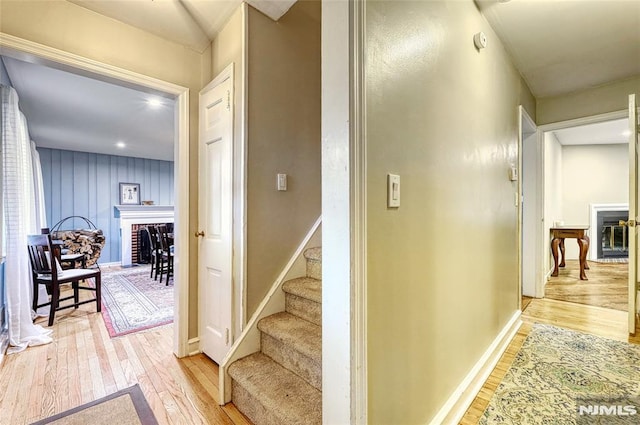 hallway with light hardwood / wood-style floors