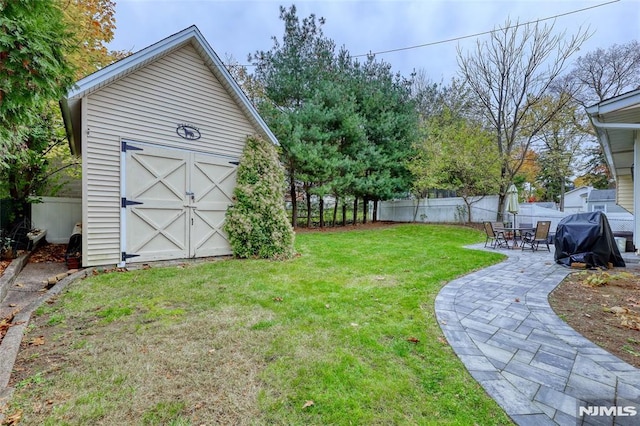 view of yard featuring a patio and a storage shed