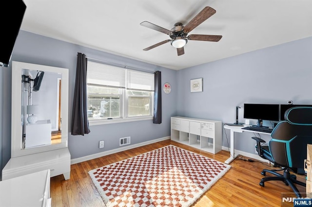 home office featuring hardwood / wood-style floors and ceiling fan