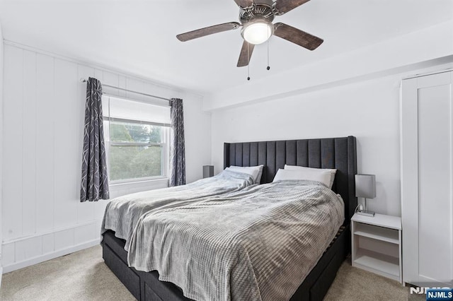 bedroom with ceiling fan and light colored carpet