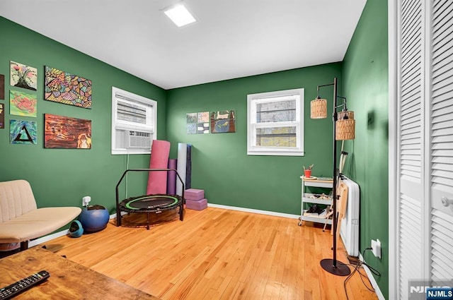 sitting room featuring cooling unit and light hardwood / wood-style floors