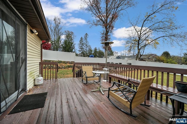 wooden terrace featuring a yard