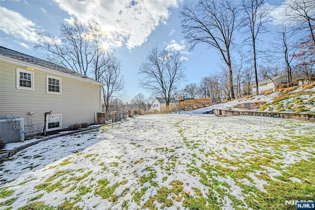 snowy yard with central AC