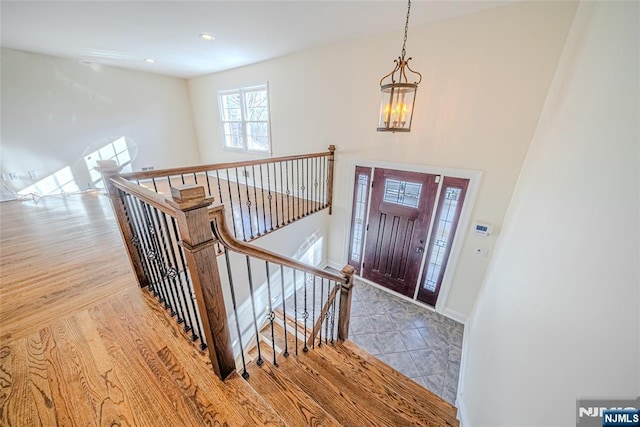 entrance foyer featuring light hardwood / wood-style flooring and a notable chandelier