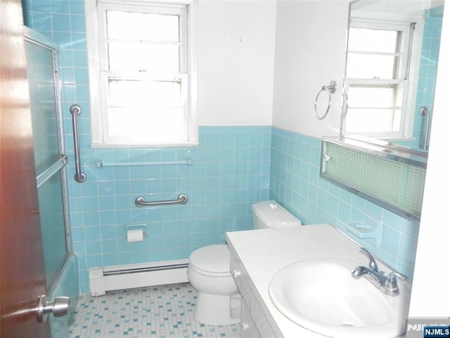 bathroom with vanity, shower / bath combination with glass door, a baseboard radiator, tile walls, and toilet