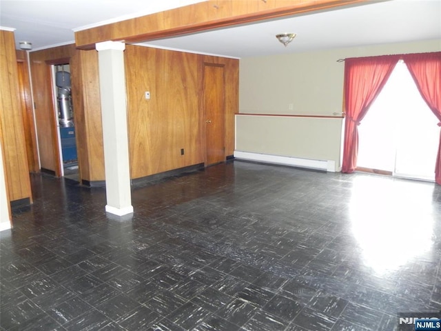 unfurnished room featuring tile patterned floors, a baseboard heating unit, wood walls, and ornamental molding