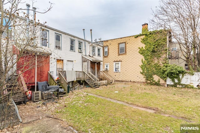 rear view of house with a lawn