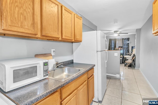 kitchen featuring light tile patterned flooring, white appliances, ceiling fan, and sink