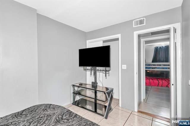 bedroom featuring light tile patterned flooring