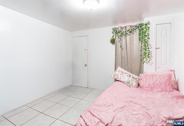 bedroom with light tile patterned flooring