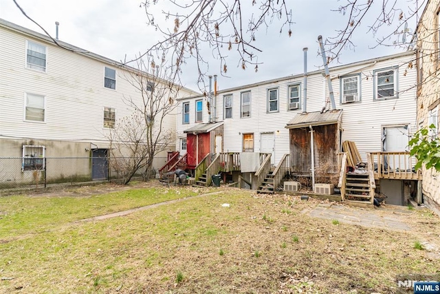 rear view of property with a lawn