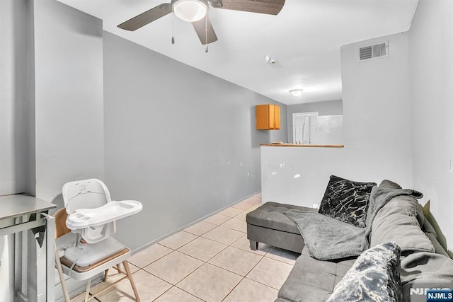 tiled living room featuring ceiling fan