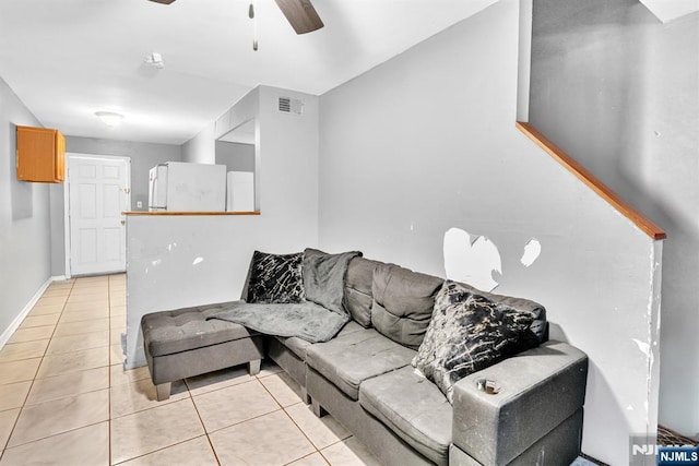 tiled living room featuring ceiling fan