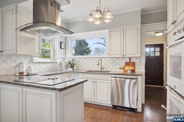 kitchen with black electric stovetop, white cabinets, a sink, island range hood, and dishwasher