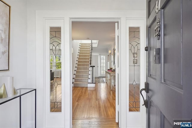 entryway with stairs and wood finished floors