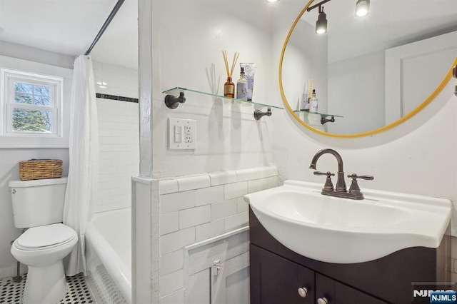 bathroom with vanity, toilet, and shower / bath combo with shower curtain