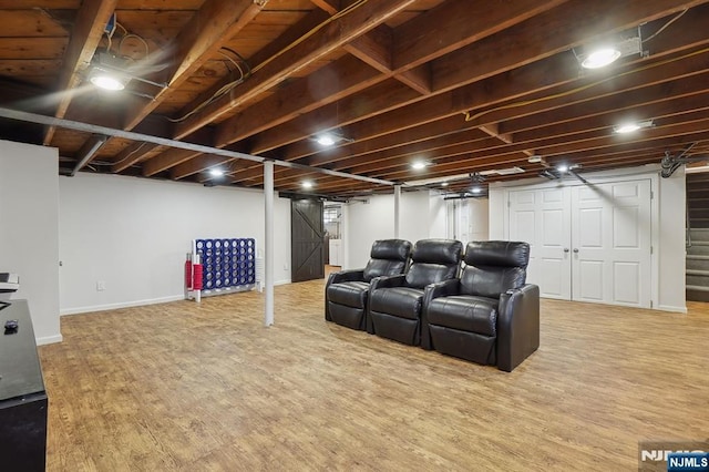 cinema room featuring wood finished floors and baseboards