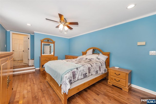 bedroom featuring ornamental molding, ceiling fan, and light hardwood / wood-style floors