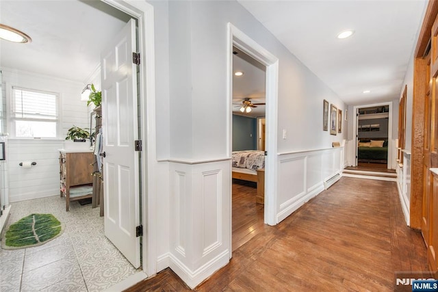 hallway with a baseboard radiator and wood-type flooring