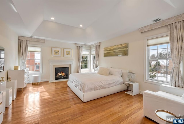 bedroom featuring vaulted ceiling and light hardwood / wood-style flooring