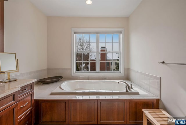 bathroom featuring tiled tub