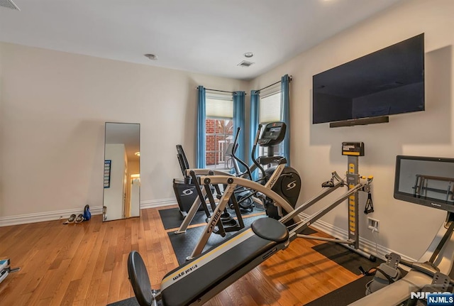 exercise area featuring hardwood / wood-style flooring