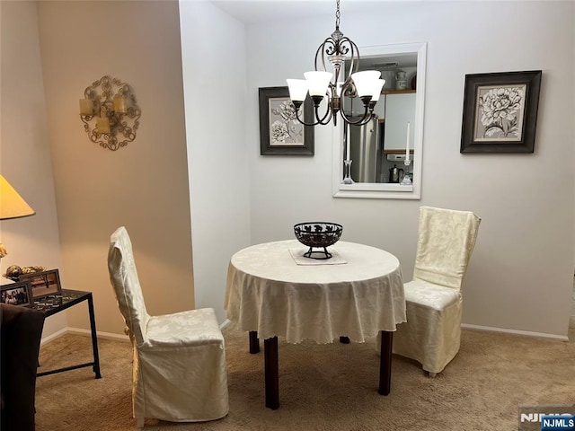 dining room with a chandelier and carpet floors