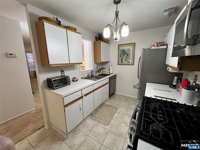 kitchen featuring stainless steel appliances, white cabinetry, pendant lighting, and light tile patterned flooring