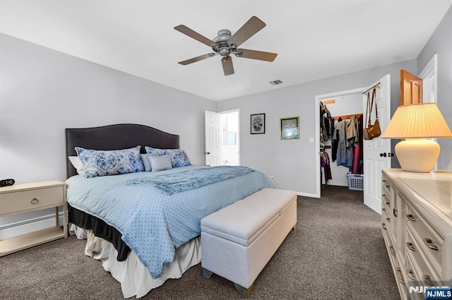 carpeted bedroom featuring a spacious closet, ceiling fan, and a closet