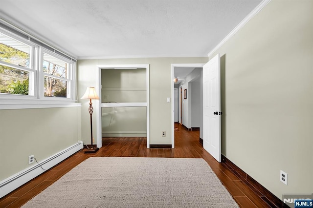 bedroom with baseboard heating, crown molding, and dark wood-type flooring