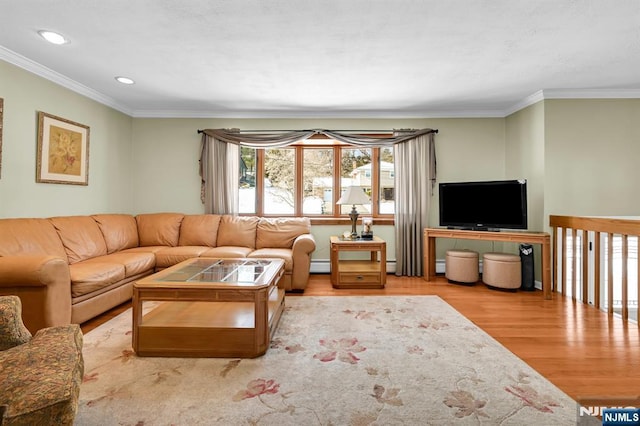 living room with ornamental molding, light hardwood / wood-style floors, and baseboard heating