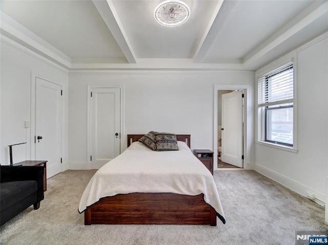 bedroom featuring light colored carpet and beam ceiling