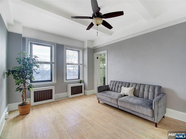 living room featuring ceiling fan, radiator heating unit, and light hardwood / wood-style floors