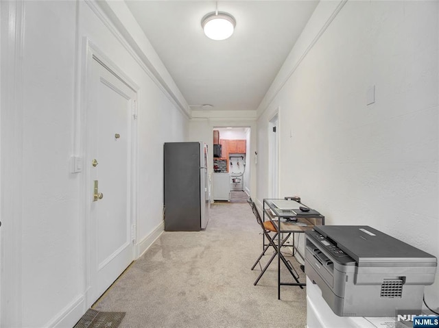 hallway with light colored carpet