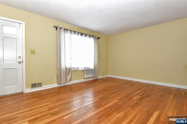 empty room with hardwood / wood-style floors