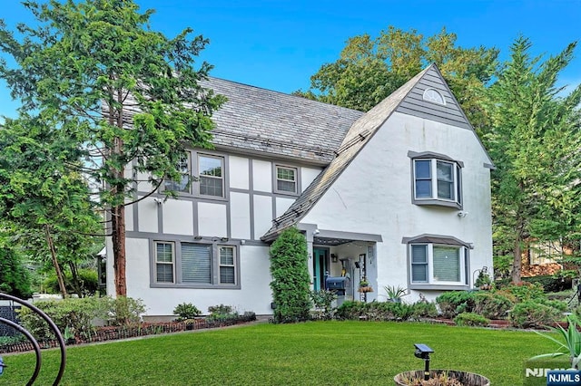 tudor house featuring a front yard